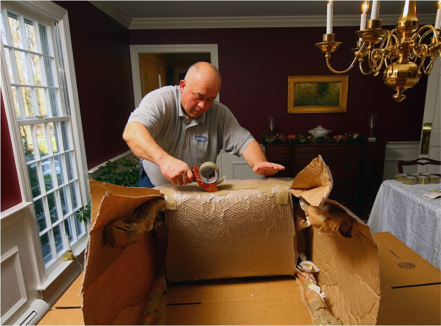 Professional mover packing boxes