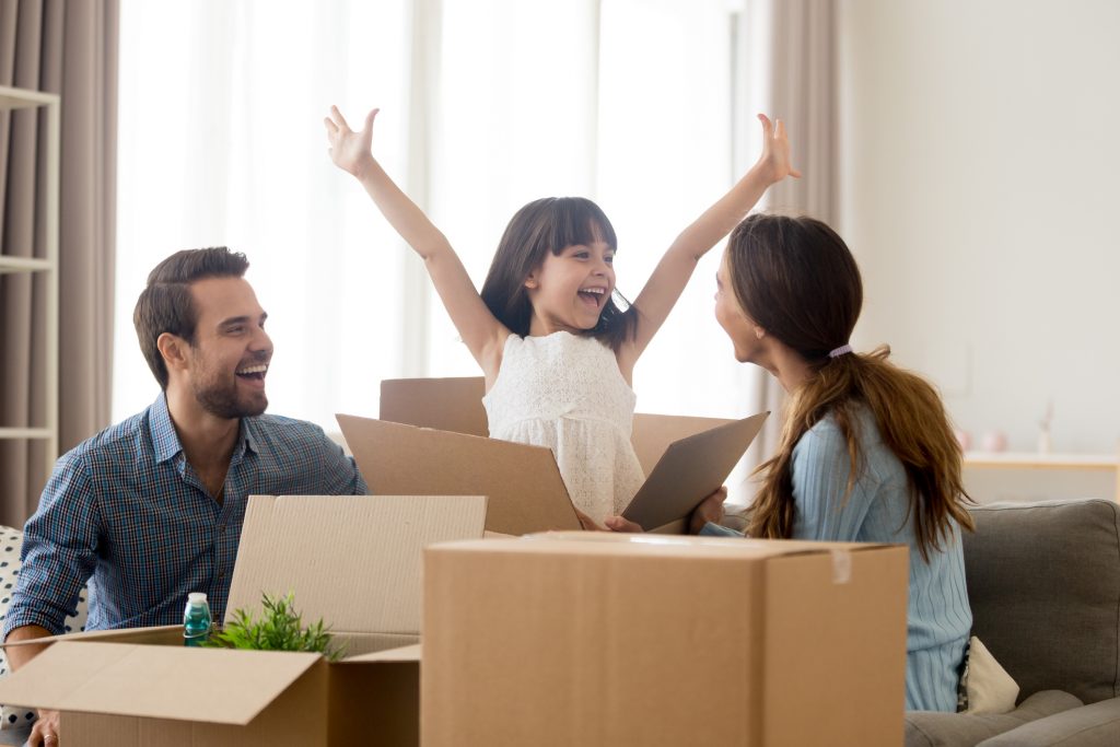 couple with girl jumping out of moving box