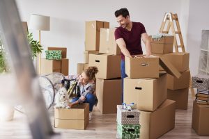 couple with dog moving in with boxes
