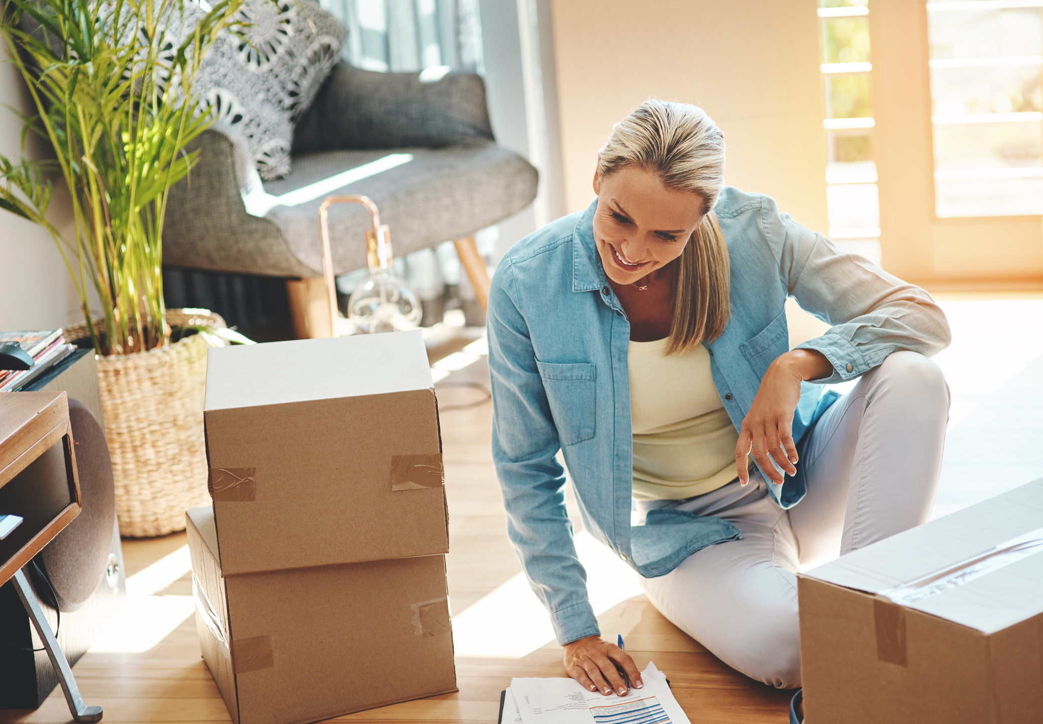 mature woman reviewing paper on moving day