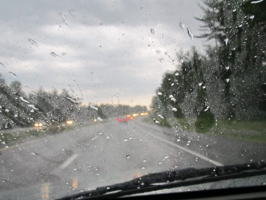 Shot from inside car winshield driving in the rain with wipers working