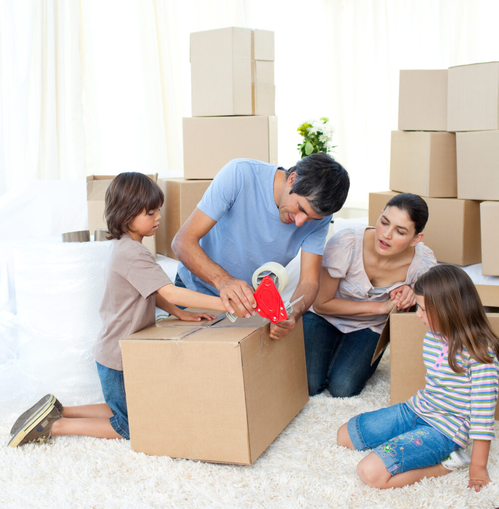 Family excitedly packing moving boxes